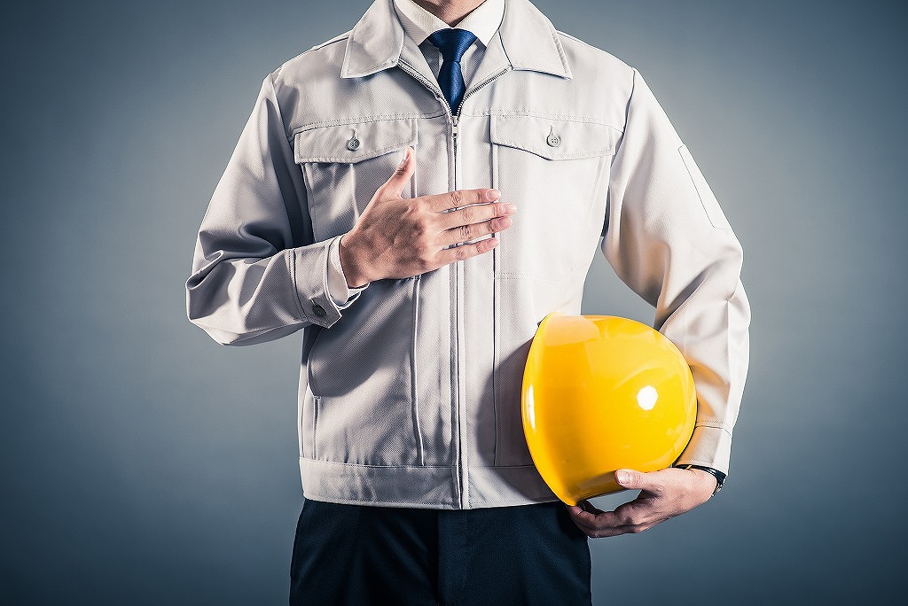 胸に手を当てるスタッフ